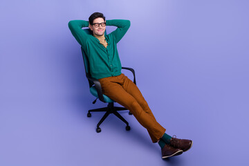 Photo of dreamy nice gentleman wear stylish outfit sit comfort chair hold arms behind head empty space isolated on violet color background