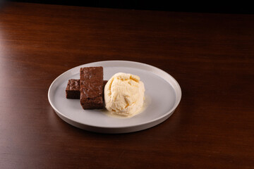 brownie dessert with scoop of vanilla ice cream