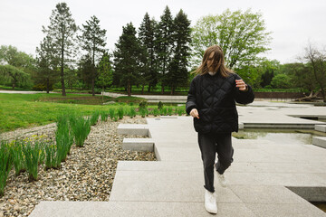 Fototapeta premium Sweet little girl outdoors with hair in the wind.