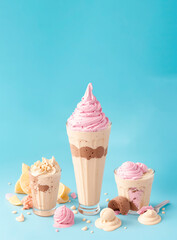 ice cream in glass cups of different sizes with a light blue background
