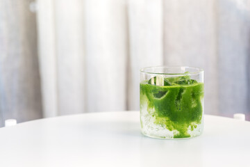 ice Matcha (green tea) soda refreshing drink on white table