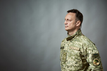 Ukrainian military man, in military uniform. On the sleeve there is an inscription in Ukrainian -...