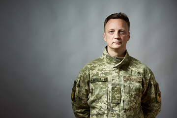 Ukrainian military man, in military uniform. On the sleeve there is an inscription in Ukrainian -...