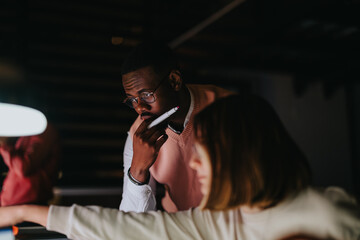 Diverse business team analyzing stats, discussing strategies, working together to achieve success.