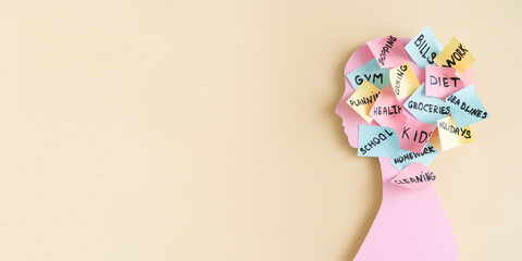 Mental load concept - female pink profile, head covered with post-it notes with different life...