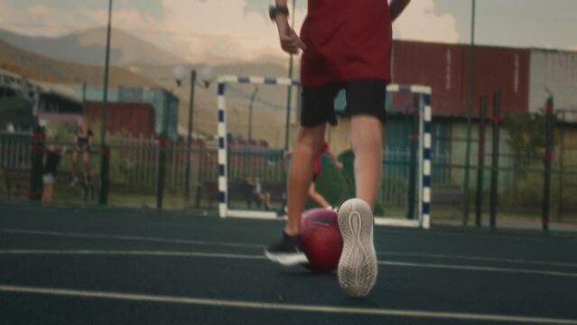 Young attacker strikes soccer ball trying to score and hopes for successful outcome. Sporty teenager kicks ball with determination to make successful shot and secure point for team