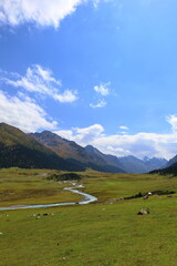 Fototapeta na wymiar Turgenaksu valley with a river wading on a second stage of Ak-Suu Traverse trek in Karakol, Kyrgyzstan
