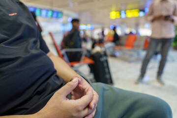 Man waiting for flight in airport departure area at airport waiting the flight