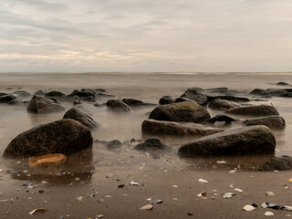 Timeless Motion: Serene Seascape with Rocks in Long Exposure, Capturing Nature's Fluidity and Stillness in Harmony