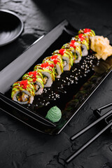 Avocado Sushi roll japanese food on black plate