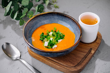 Pumpkin soup with pesto with spoon