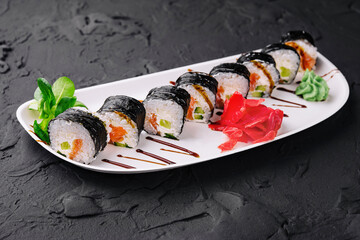 nori sushi rolls with salmon on plate