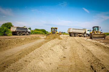 Bulldozer machine is leveling construction site.