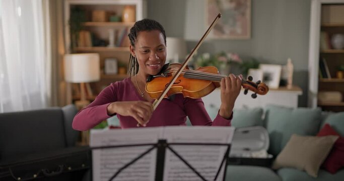 Woman enjoys violin practice in a serene home setting