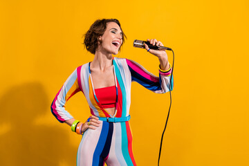 Photo of crazy freak girl wearing old style nostalgia striped costume singing microphone karaoke vocal isolated on yellow color background - obrazy, fototapety, plakaty