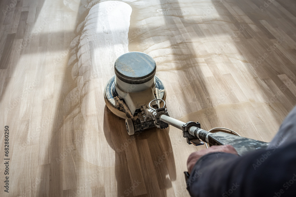 Wall mural polishing wooden parquet floor with special orbital machine