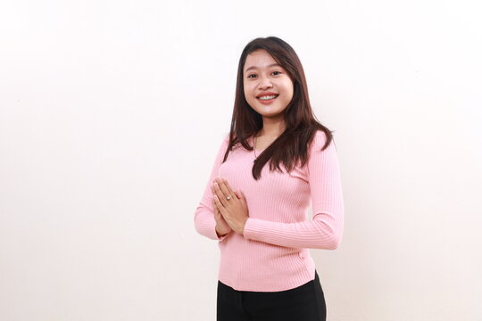 Confident young asian girl standing with welcoming gesture. Isolated on white background