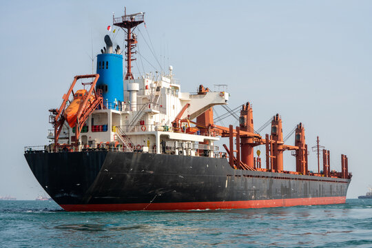 cargo ship in the ocean for export import goods from cargo yard port to customs ocean concept freight shipping by ship