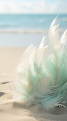 A serene display of pale blue and seafoam green feathers with waves on a sandy background. Vertical. 