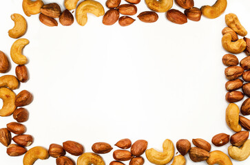 Rectangular frame of mixed nuts on white background isolated