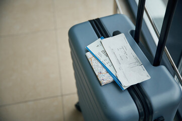 Luggage bag with tickets for flight on it, close up view