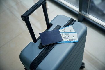 Luggage bag with tickets for flight on it, close up view