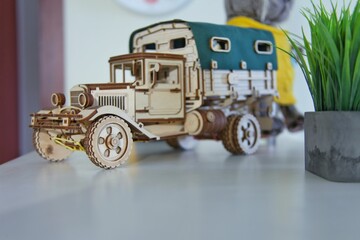 Wooden truck on a table in a children's room. Wooden construction toy for developing logic in...