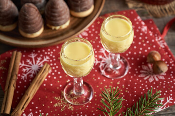 Two glasses of eggnog with wasp nests - no-bake Christmas cookies in the background