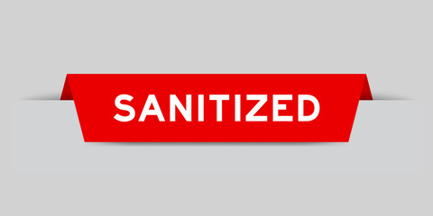 Red color inserted label with word sanitized on gray background
