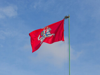 The historical state flag of Lithuania, known as the Vytis, consists of a red banner depicting a mounted knight in pursuit, on the center. In the background of the blue sky.