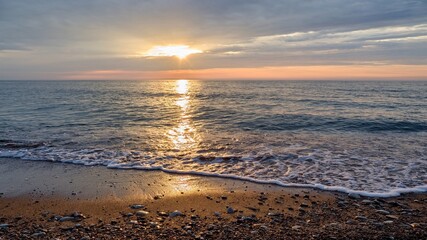 The rays of the sun shine through the clouds. Colorful cloudy sky at sunset. Gradient color. Sky texture, abstract nature background. Positive photography.