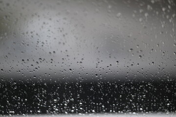 Water drops on fogged glass with a gray brightness gradient