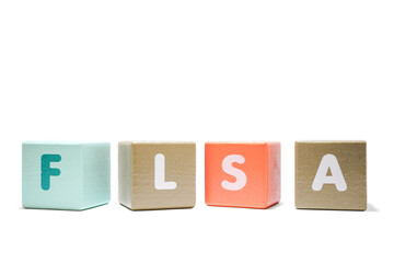 text FLSA Fair Labor Standards Act on colorful wooden isolated on a white background