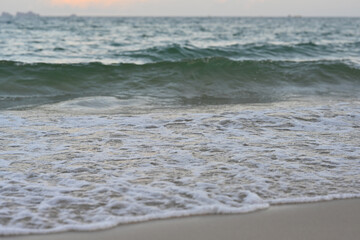 Soft foam wave of the sea on the sandy beach