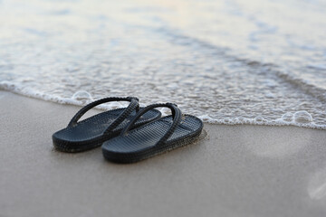 Flip Flops on the beach, sandals on a tropical beach, relaxing travel vacation concept