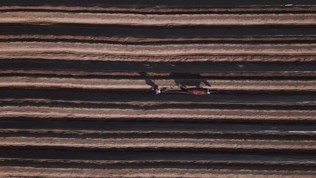 Aerial view of a man working the field with his horse. High quality 4k footage