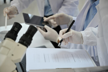 Close-up of the lab team scientist experimental experts of various ages Discuss research and Record...