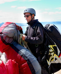 Paragliding, parachute or man in nature for sport, preparation or helmet to exercise for health...