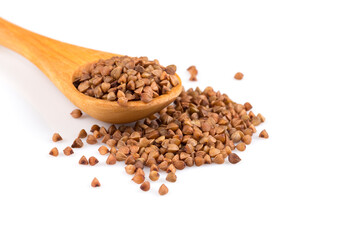 Uncooked buckwheat on wooden spoon