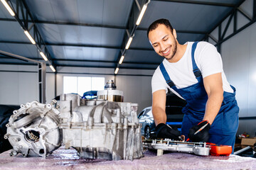 Electric car engine removed from car for repair. Arabian man use voltmeter working Internal Permanent Magnet Synchronous Reluctance Motor. Service maintenance of industrial to engine repair.