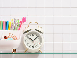 Office supplies and a retro alarm clock. Education concept. Copy space for text.