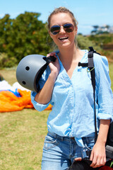 Woman, parachute and field happy for skydiving summer, fearless or outdoor adventure. Female...