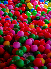 Colored plastic balls in pool of game room.