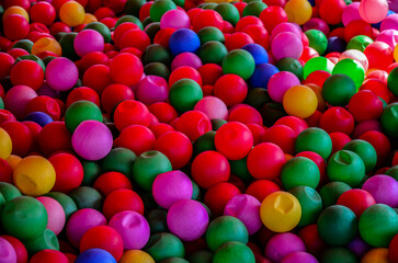 Fototapeta na wymiar Colored plastic balls in pool of game room.