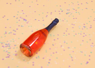A celebratory bottle of champagne and confetti. Birthday decoration. Copy space for text.