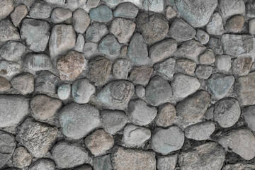 Stones cobblestones gray cement wall solid texture background rough street rock surface grey