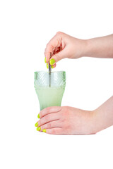 Woman mixing powdered medicine or protein in a glass of water on a white background.