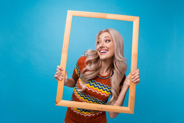 Photo of thoughtful excited lady wear print shirt shooting photo looking empty space isolated blue...