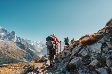 Group of hiker hiking with difficult on mountain trail amidst French alps on sunny day at France - 682930667