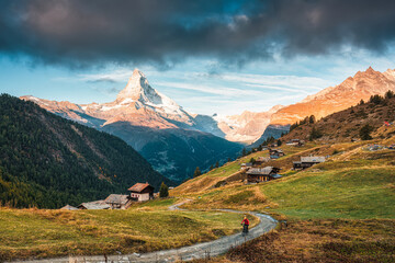 Matterhorn iconic mountain and small village of wooden huts on the hill at Zermatt, Switzerland
